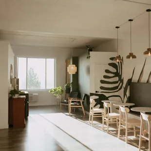 a living room with a dining table and chairs