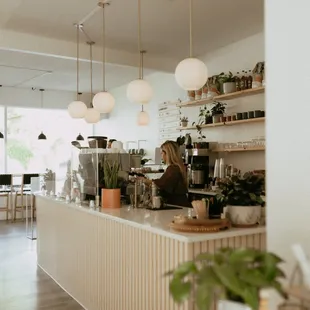 a coffee shop with people standing in the background