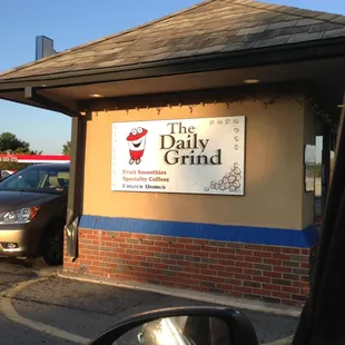 the sign for the daily grind