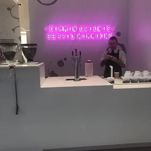 Barista hard at work and neon sign