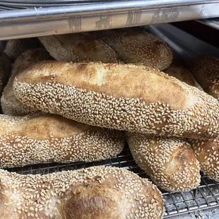 a bunch of loaves on a cooling rack