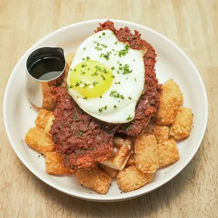 NASHVILLE HOT CHICKEN (BRUNCH) - rosemary cheddar waffle, Nashville crispy chicken, 
sunny egg, tots