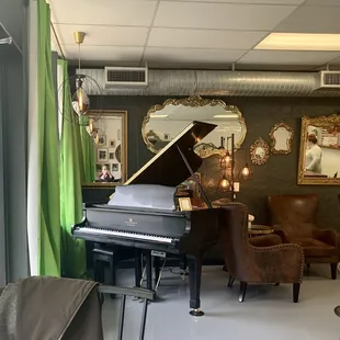 a living room with a grand piano