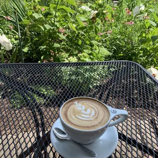 Enjoying a latte in the outdoor courtyard across the street