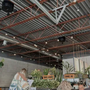 people sitting at tables in a restaurant