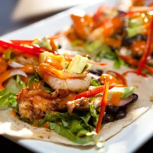 Fish Tacos, spiced black bean, avacado, shaved chiles and onions, cilantro, carrot hot sauce