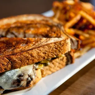 Mushroom Melt, pastrami spiced portabella, sauerkraut, sweet pickles, gruyere. mustard aioli, rye
