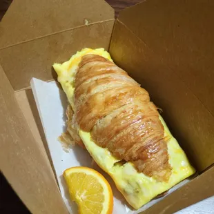 Breakfast croissant with bacon and tomatoes mixed in, added cheese