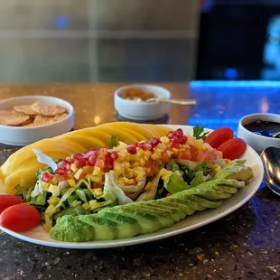 Mango and avocado salad with pomegranate and sweet vinaigrette dressing.