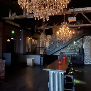 a dining room with a chandelier and a bar