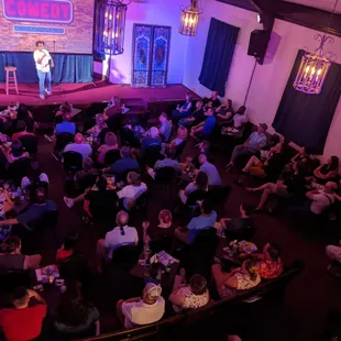 a man on a stage speaking to a crowd