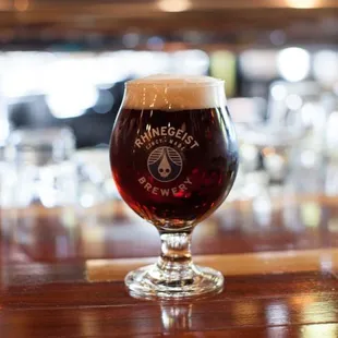 a glass of beer on a bar