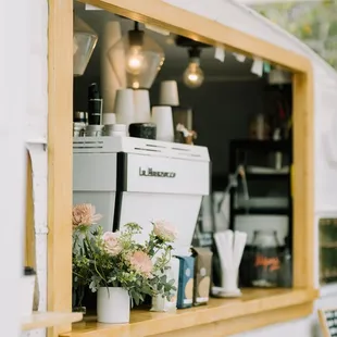 a coffee truck with a potted plant in the window