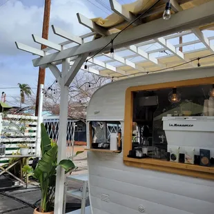 a food truck with a surfboard on the roof