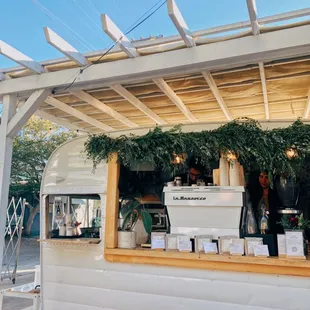 a food truck with a coffee machine in the back