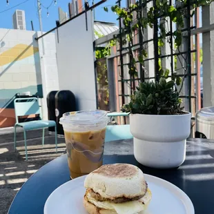 Salted maple sausage sandwich and iced vanilla latte with oatmilk