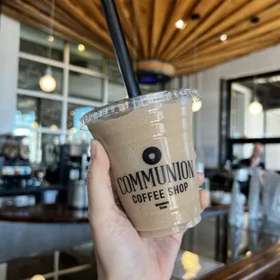 a hand holding a cup of coffee