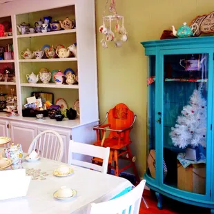 a blue china cabinet in the corner of the room