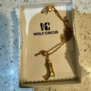 my new fav necklace - gold cowboy boot on a chain, perf for Tejas!