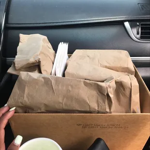 a box of food and a cup of coffee