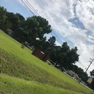 a grassy area with power lines in the background