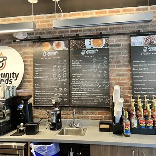 a coffee shop with a menu on the wall