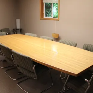 a large conference table with chairs