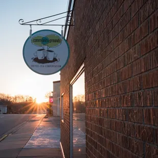 a brick building with a sign that reads community grounds