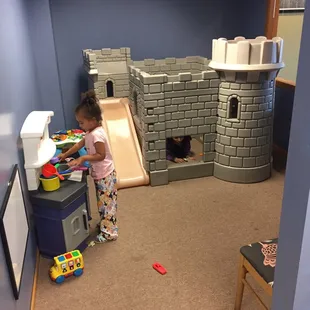 a little girl playing in a castle