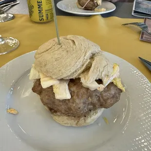 Dumpling burger on a baked bao - ground pork, scallions, red onion, napa cabbage, cilantro, cucumber, and hoisin