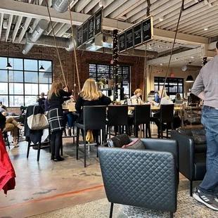 people sitting at tables in a cafe