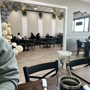 a man sitting at a table with a cup of coffee