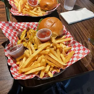 two baskets of french fries and a burger