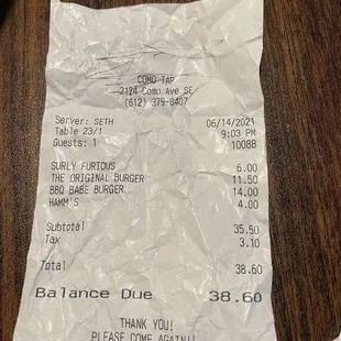 a receipt on a wooden table
