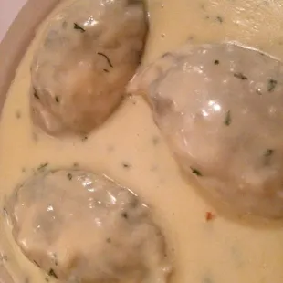 Spinach and cheese stuffed ravioli with cream sauce.