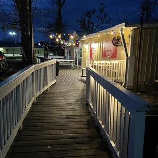 a wooden walkway leading to a restaurant