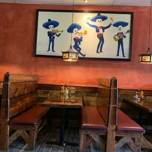 a mexican restaurant with a large painting on the wall