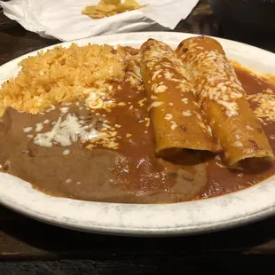 a plate of enchiladas and rice