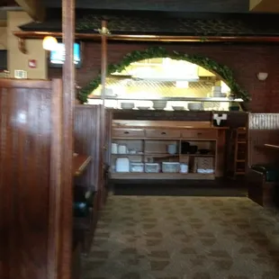 the inside of a restaurant with wooden booths