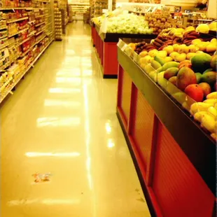 a grocery store aisle with fruits and vegetables