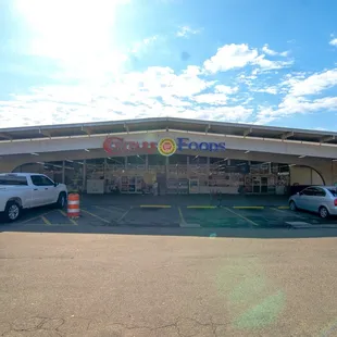 two cars parked in front of a store