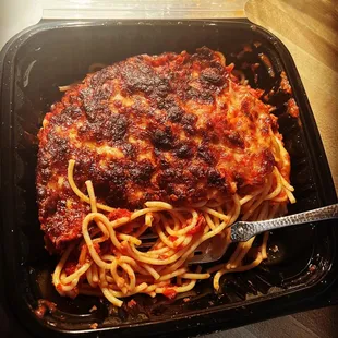 Spaghetti with melted cheese.