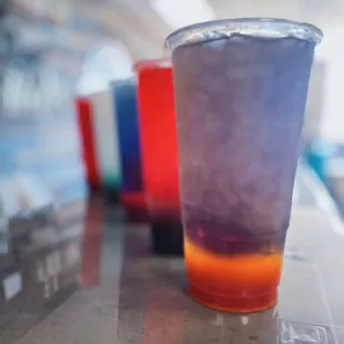 a colorful drink in a plastic cup