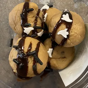 a bowl of cookies with chocolate drizzle and sprinkles