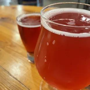 two glasses of beer on a wooden table