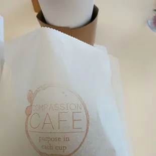 a cup of coffee and a paper bag