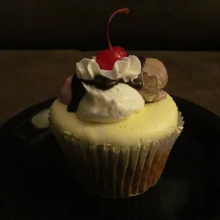 Banana split cupcake: banana cake with 4 kinds of frosting (banana, vanilla, chocolate, and strawberry) and chocolate topping