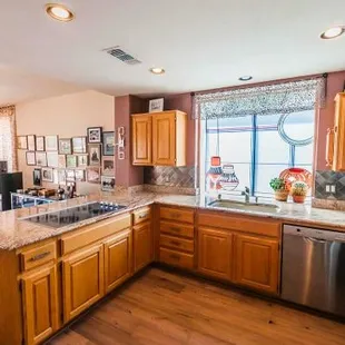 a kitchen with wooden cabinets and a stainless steel dishwasher