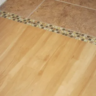 Karndean LVP with decorative band transitioning to existing ceramic tile floor = looks better than we&apos;d dreamed it would!