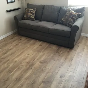Complete Flooring installed Century Oak laminate in a guest bedroom.